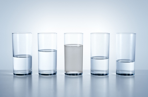 Different levels of water glasses, water shortages in different regions symbolizes. Also dirty water in the middle is symbolized clean water crisis.