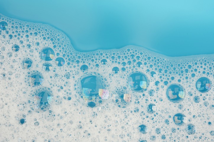 Bubble foam on blue water surface background top view; Gettyimages: 1043438066