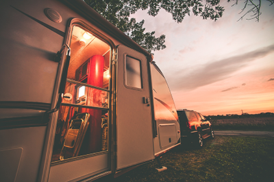 Hero Image Travel Trailer Camping. RV Trip Theme. Evening in RV . Vintage Color Grading.