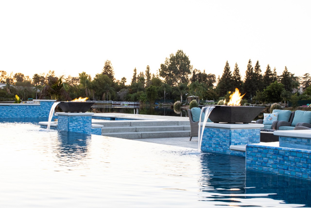 MagicFlame at dusk in a big pool with trees and sky in the background